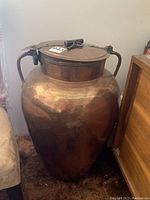Full view of copper urn with lid and side handles
