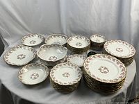 Overview of entire china set arranged on fabric backdrop