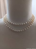 Necklace wrapped twice on mannequin to show double-wrap styling