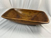 Front perspective of rectangular pine dough bowl on white fabric backdrop