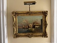 Frontal view of framed painting with art light