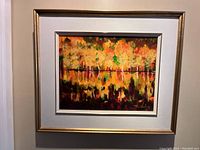 Overall view of framed painting with attached light