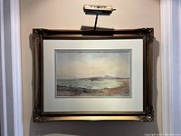 Overall view of the watercolour painting in ornate frame with wall-mounted picture light