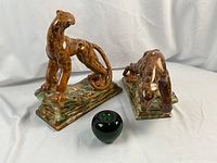 Both leopards with green glass apple size reference
