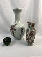 Overview of two vases with green glass apple for scale