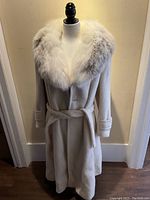 Full front view of the coat on a dress form