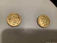 Two separate gold coins dated 1888 and coin portrait sides.
