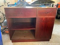 Front view of the solid wood cupboard showing two drawers, open shelf, and cabinet door.