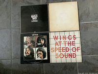 Four Beatles LP records including Wings and The Beatles Tapes double album, Let It Be, and White Album; all covers shown.