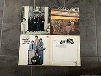 Top view of four Beatles LP records showing album covers for identification.