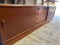 Front view of credenza showing sliding doors closed and central drawers