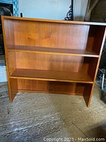 Front view of Mid-Century Modern teak hutch bookshelf showing two shelves and teak finish.