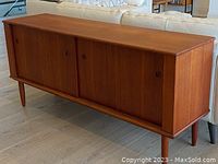 Front view of teak sideboard, sliding doors closed