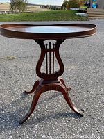 Full view of oval tray side table showing lyre pedestal base and splayed legs