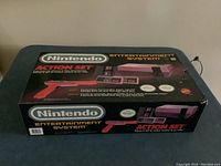 Closed NES Action Set box, front and top view