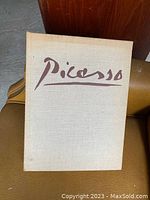 Front cover of the hardcover Picasso book with beige cloth and stylized title.