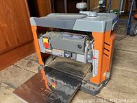 Front view of the Ridgid benchtop thickness planer showing infeed table and control panel