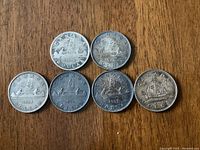 Overview of all six Voyageur silver dollars displaying each date.