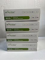 Stack of ReGentox Nitrile Gloves boxes, white with green labeling, each labeled as powder free disposable nitrile gloves 350g/400g weight.