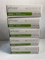 Five stacked boxes of ReGentox blue nitrile gloves marked as powder free and disposable, size Medium checked on each box.