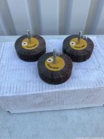 Three mounted flap wheels on a box, showing the 080 grit marking and 20000 RPM speed rating.