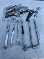 Tray of various wrenches including combination, specialty, and tire irons shown together on a surface