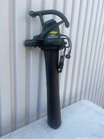 Full view of the green and black Yardworks electric blower/vac with handle and power cord, showing overall condition.