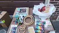 Overview of crafting materials including string art kit, yarn, embroidery hoops, and paintbrushes.