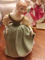 Front view of Royal Doulton Fair Maiden figurine in green dress seated pose