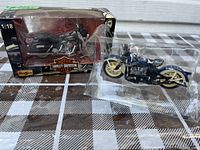 Two motorcycle models, one in box, one only in plastic packaging outside box, Harley Davidson 1:18 scale