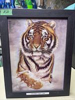 Framed 3D art showing a tiger with realistic fur inside a dark frame.