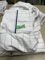 Folded Nautica bed sheets set showing white cotton fabric with stitched diagonal line pattern and navy stripe accent on pillowcase.