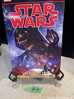 Front cover of the Star Wars comic book showing Darth Vader with spaceships and cosmic background, titled The Empire Legends.