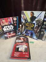 Lot contents with Star Wars Lightsaber Rescue and Jedi Training electronic handheld games and spiral notebook
