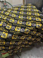 Blanket spread out showing the patchwork design featuring Hamilton Tiger-Cats logos and colors.