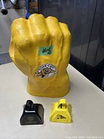 Yellow fist sculpture with Tiger-Cats logo, approximate height 11 inches, showing size and condition.