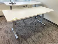 Front and side view showing dual-level white laminate surfaces and silver metal frame