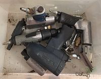 Bin with various pneumatic tools including drivers, ratchet, cutter, drill, untested with fittings
