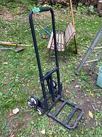 Front left angle of black metal step climber dolly with six wheels.