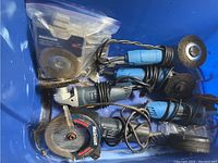 Bin containing five Mastercraft angle grinders with various attachments including wire brush wheels and abrasive discs.