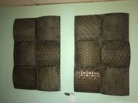 Two 2-piece textured metal wall art sets hung on wall, each with nine textured square panels, close view to show patterns and layout