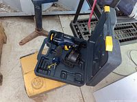 Photo of the Mastercraft air-powered coil roofing nailer inside a molded plastic carrying case, with hex keys.