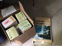 Box containing multiple smaller boxes of disposable toilet waste bags and the packaged portable toilet