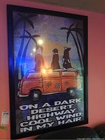 Framed poster showing three dogs on an orange van with palm trees and text