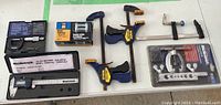 Full lot overview showing electronic caliper, micrometer, clamps, flaring tool, roller fairlead and packaging.