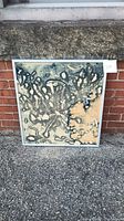 Front view of abstract batik artwork showing organic black and beige patterns. Mounted in a silver frame.