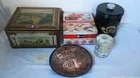 Overall lot with tins, wooden box, decorative plate, and enamel tray visible