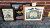 Three vintage bar mirrors displayed outdoors on a brick surface, showing Miller Genuine Draft, Molson, and Jack Daniel's No. 7 branding.