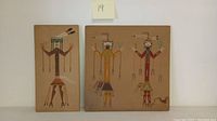 Photo of first two sand art panels showing Native American styled figures in traditional clothing and poses, displayed vertically.