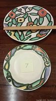 Both ceramic platters shown stacked, measuring approximately 14 inches in length for the oval.